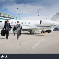 stock-photo-executive-business-team-leaving-corporate-jet-261806267